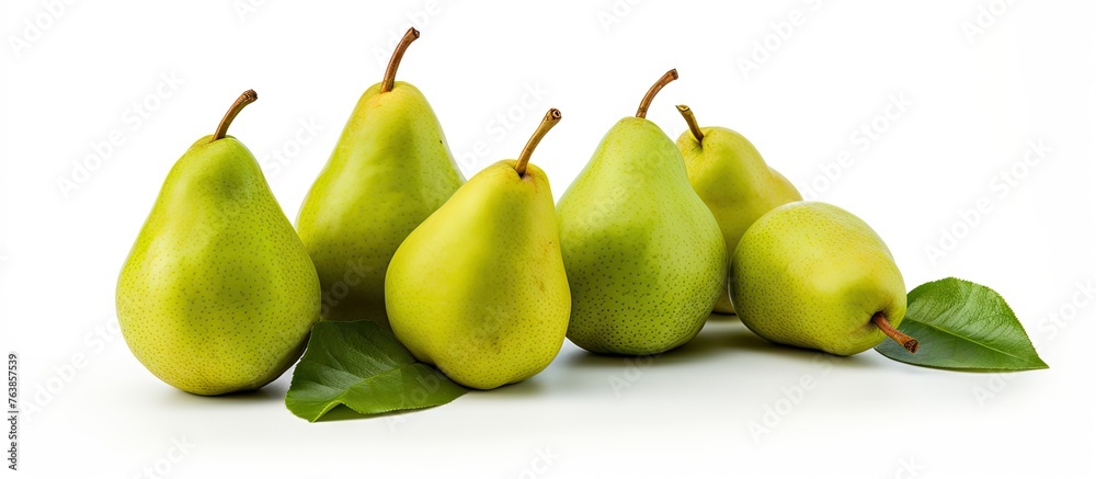 Close-up of pears with leaves on white surface Close-up of pears with leaves on white surface