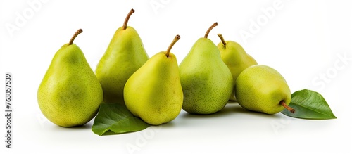Close-up of pears with leaves on white surface