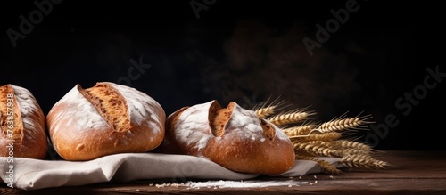 Three bread loaves on napkin with wheat ears