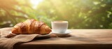 A croissant and coffee on a table