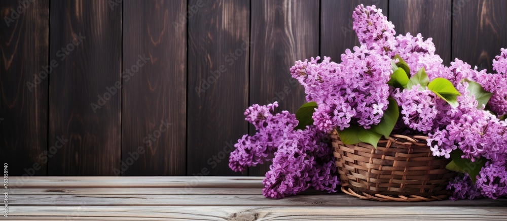 Fototapeta premium Lilac flowers in a wooden basket