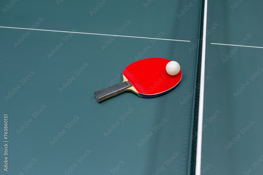 Table tennis ball and racket on the table - stock photo Table tennis ball and racket on the table - stock photo