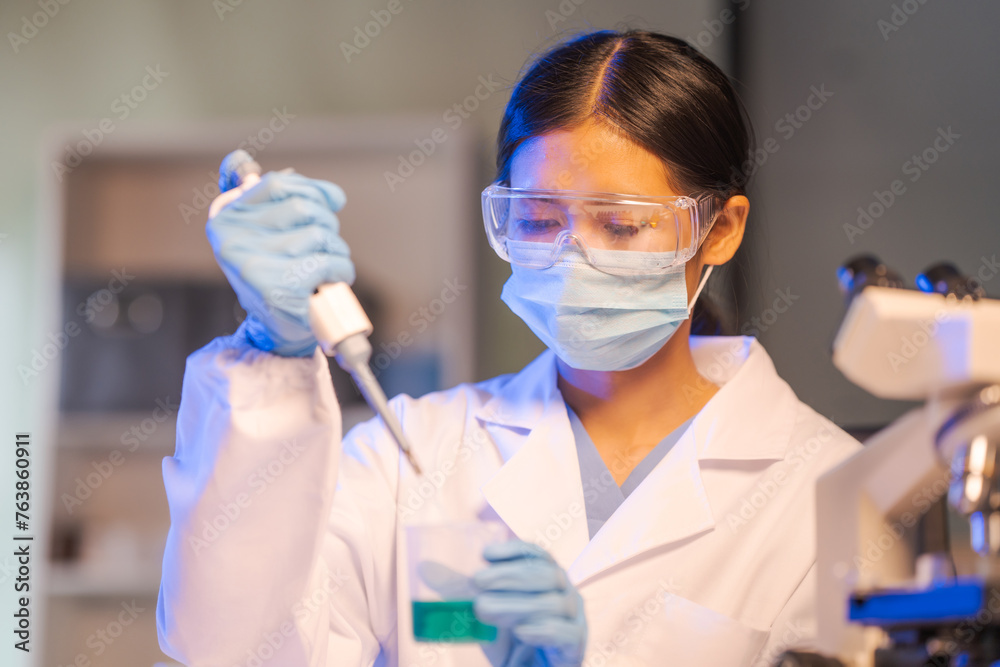 Close up female scientist in white lab coat working in biotechnological laboratory, using microscope, pipette, glass flask in clinical laboratory. Close up female scientist in white lab coat working in biotechnological laboratory, using microscope, pipette, glass flask in clinical laboratory.