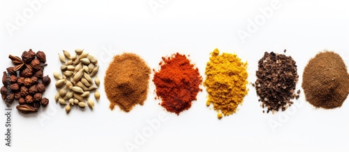 A close up of a row of spices on a white surface