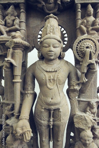  A finely detailed stone sculpture of a Jain Tirthankara Parshvanatha,  with a serene expression, surrounded by ornate carvings photo