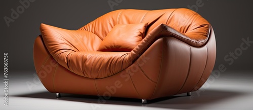 A close up of a comfortable brown leather chair featuring a soft pillow resting on top