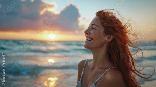 female with red hair smiling and carefree enjoying leisurely walk along the beach at sunset vacation moment