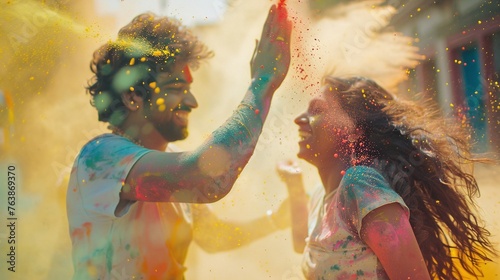 happy hindu indian people celebrate holi festival by throwing colorful powder at each other