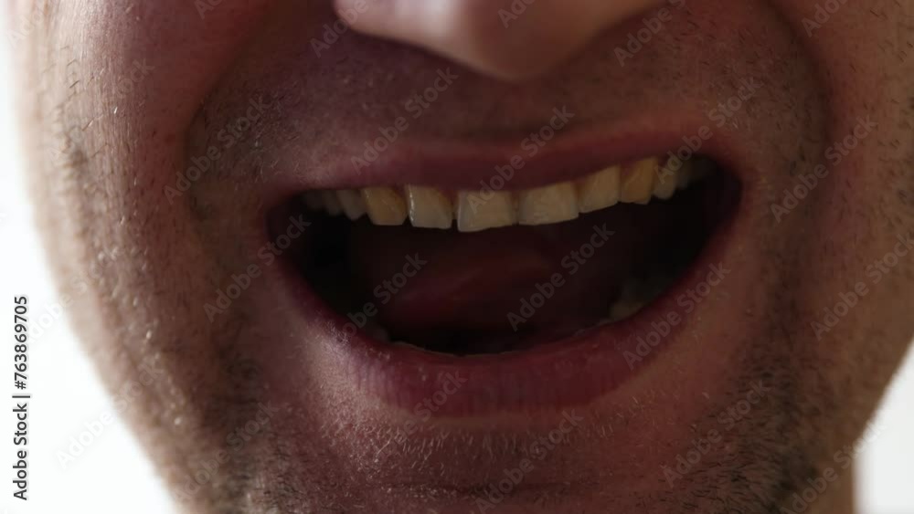 Man's mouth grimaces at camera. Slight unshaven face Man's mouth grimaces at camera. Slight unshaven face