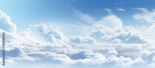 There is a plane flying through the clouds in the sky