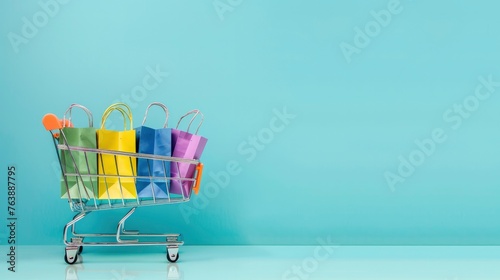A shopping cart with colorful paper bags on a light blue background.