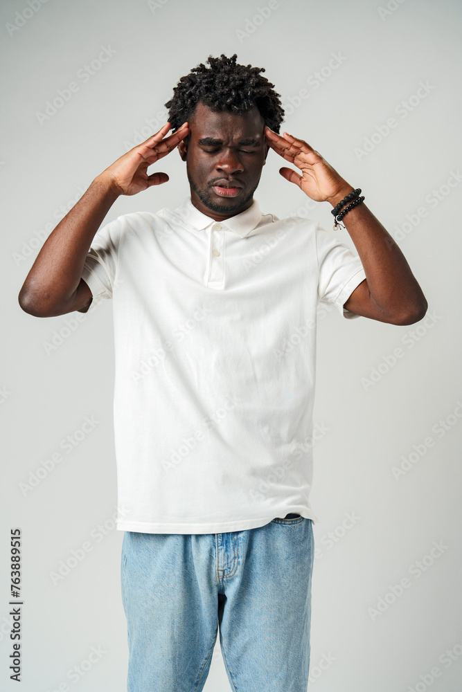 African man with his hands on his head, expressing frustration and stress African man with his hands on his head, expressing frustration and stress