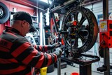 A man meticulously aligning the wheels of a bike using specialized equipment in a garage workshop