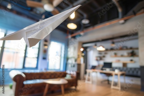 paper airplane flying across a coworking space, motionblurred photo