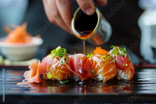 person drizzling soy sauce over sashimi