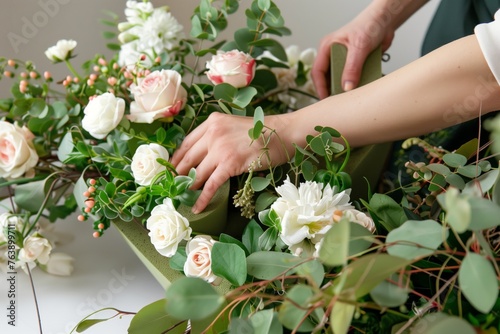 person arranging a flower arrangement with floral foam