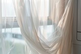 air from dryer fluttering white sheer curtain