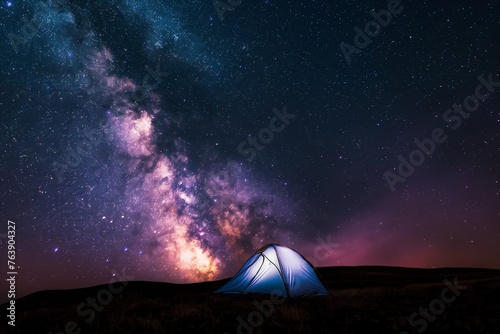 milky way across the entire sky  a small illuminated tent on the ground  night sky full of stars