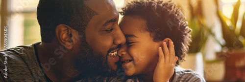 African American dad and child touching noses with affectionate smiles photo