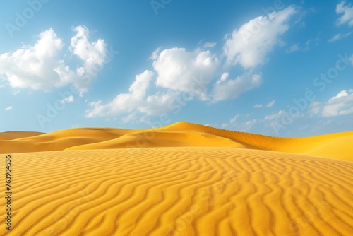 Sunset over the desert  yellow sand dunes. Waves of sand in all directions