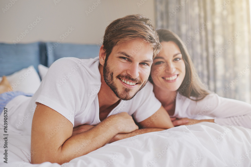 Happy, hotel and portrait of couple on bed for relaxing, bonding and resting together on vacation. Smile, romantic and young man and woman laying in bedroom at modern apartment or home on weekend. Happy, hotel and portrait of couple on bed for relaxing, bonding and resting together on vacation. Smile, romantic and young man and woman laying in bedroom at modern apartment or home on weekend.