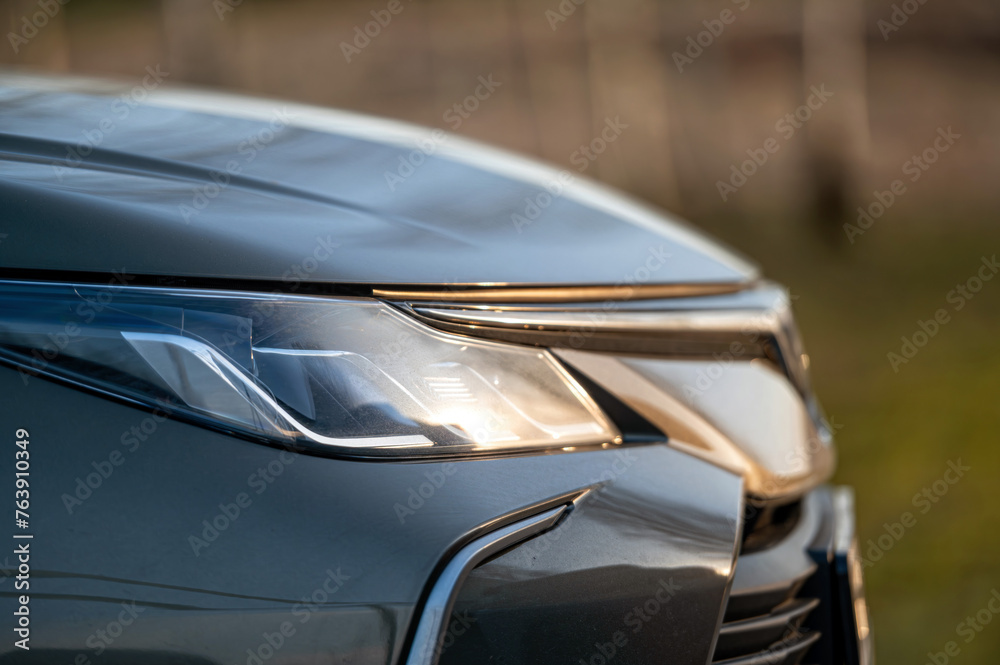 Close up of the headlight of a modern car, shallow depth of field - obrazy, fototapety, plakaty 