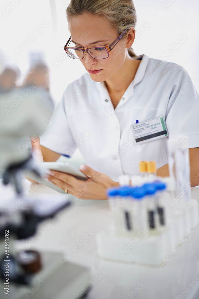 Medical, research and woman reading with tablet in laboratory with development in biotechnology. Doctor, typing or check results online of pharmaceutical report or review of innovation in science Medical, research and woman reading with tablet in laboratory with development in biotechnology. Doctor, typing or check results online of pharmaceutical report or review of innovation in science