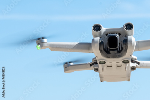 Hovering Drone in Clear Blue Sky