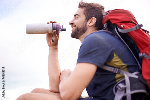 Man, hiking and break for water, health and wellness with bottle and mountain. Athlete, exercise and adventure with summer, sunshine and backpack journey on cape town trail with travel and vacation