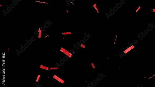 Falling shiny red confetti isolated on transparent video black background. Bright festive tinsel of red color. photo