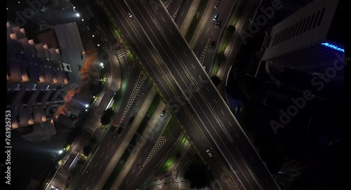 Top down aerial view of traffic on the main road passing Jakarta's  road at night. photo