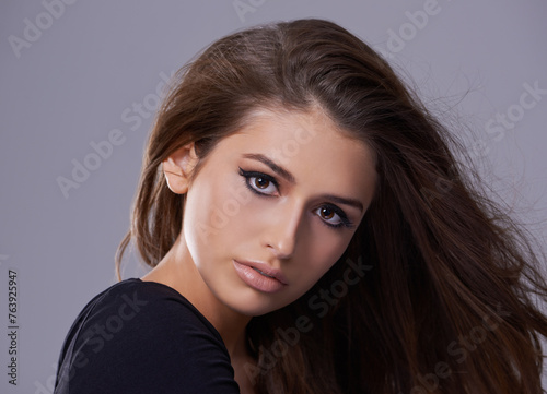 Hair, portrait and woman in studio for hairstyle, treatment and glow on isolated grey background. Shampoo, confident and face of female model with beauty cosmetics, salon and volume in mockup space