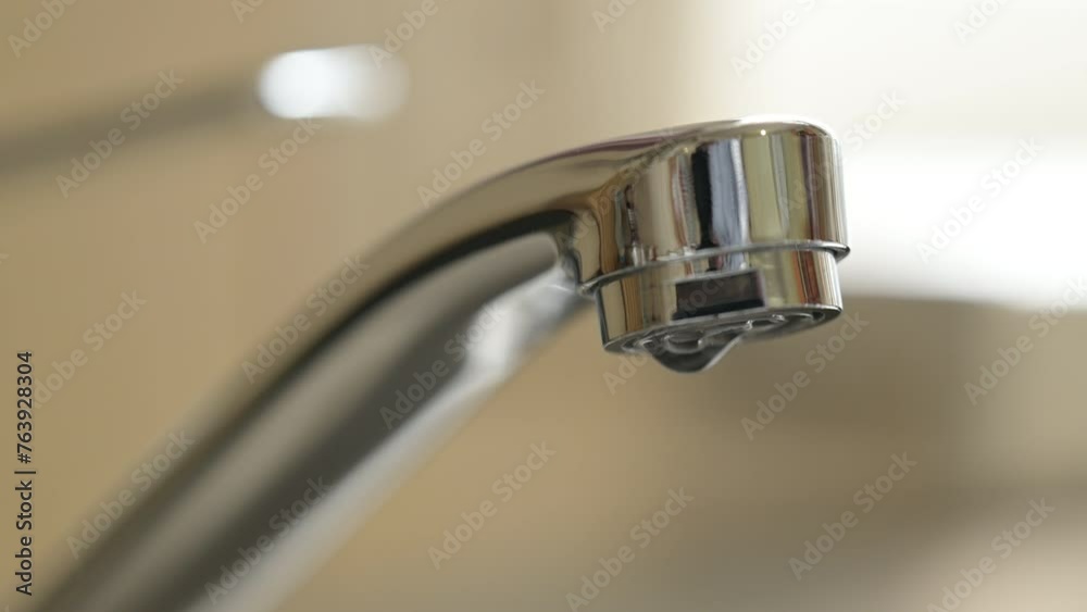 Close up on tap with dripping water. Licking water, drops one by one coming from the tap Close up on tap with dripping water. Licking water, drops one by one coming from the tap