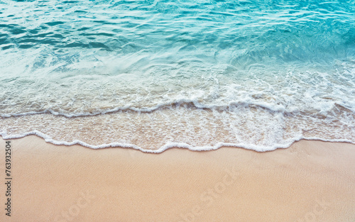 Blue ocean wave and sandy beach front view background