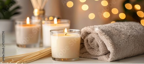Serene spa ambiance with candles and reed diffuser, ideal for relaxation in soft background