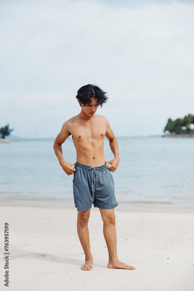 Active Asian Athlete Enjoying Beach Running in the Summer Sunset