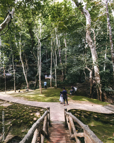 People at the moss garden near the rainforest Kelam cave in Perlis, Malaysia.