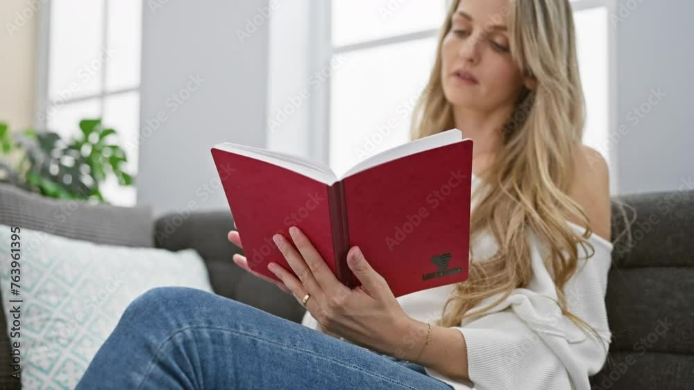 Blonde woman reading book in a cozy home interior, showcasing casual comfort and leisure. Blonde woman reading book in a cozy home interior, showcasing casual comfort and leisure.