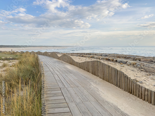 A wood pedestrian walkways  build over a sand dune that is used to give beach access in Furadouro beach  glows at sunset. Ovar  Aveiro  Portugal  Europe