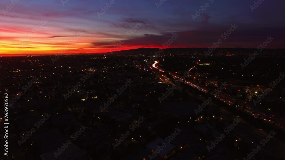 Aerial Lockdown Shot Of Illuminated Residential City By Mountains Under Dramatic Clouds At Dusk - Culver City, California Aerial Lockdown Shot Of Illuminated Residential City By Mountains Under Dramatic Clouds At Dusk - Culver City, California