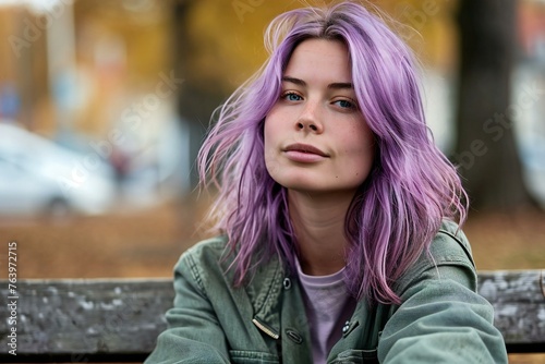 Portrait of a beautiful girl with purple hair in the autumn park photo