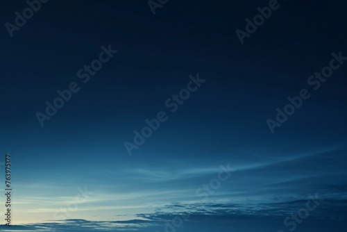 Blue sky background with tiny clouds, soft focus, and copy space