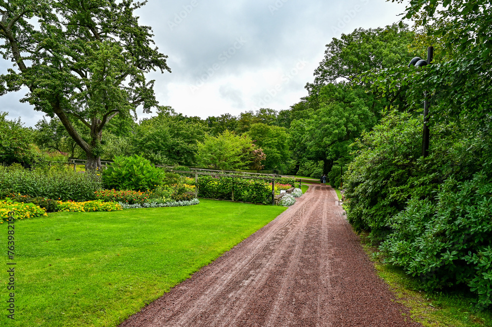 Sofiero Palace Gardens, green park with paths and large trees in Sofiero Castle, Sofiero Slott och Slottsträdgard as a tourist attraction in Helsingborg, Sweden
Sofiero Palace Gardens, green park with paths and large trees in Sofiero Castle, Sofiero Slott och Slottsträdgard as a tourist attraction in Helsingborg, Sweden