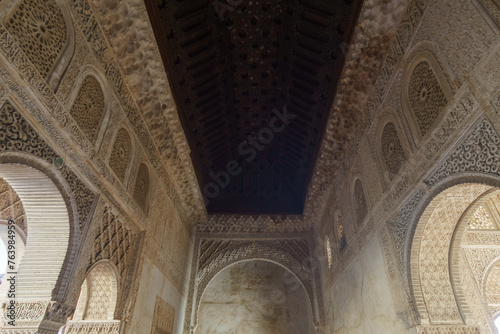 Beautiful wooden ceiling and detailed artwork on white walls  Granada  Andalusia  Spain