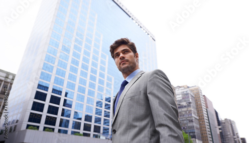 City, morning and business man for commute, travel and walking journey to office building. Corporate, low angle and male person in urban town for confidence, professional and employee for career