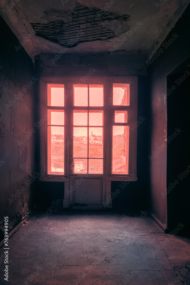 The seaside house has long been abandoned. Window overlooks to sea of Arctic Ocean