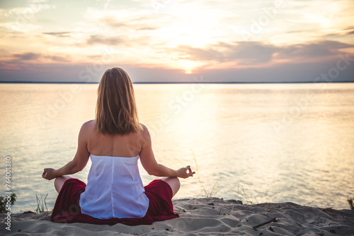 Woman meditating at the sea