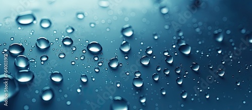 A close-up image capturing the beauty of water droplets collected on a clear window glass