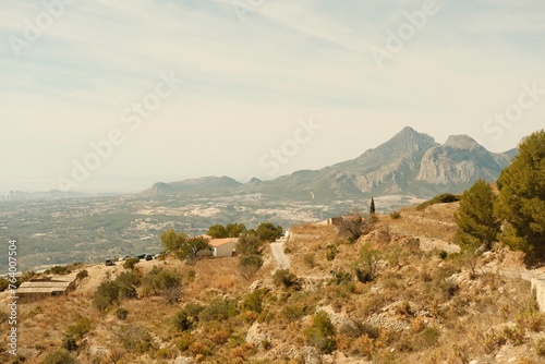 Fototapeta Naklejka Na Ścianę i Meble -  Film style photography of a landscape in Alicante, Spain. It features a foggy day with the mountains and the mediterranean sea in the background, with a dry landscape and a hiking trail.