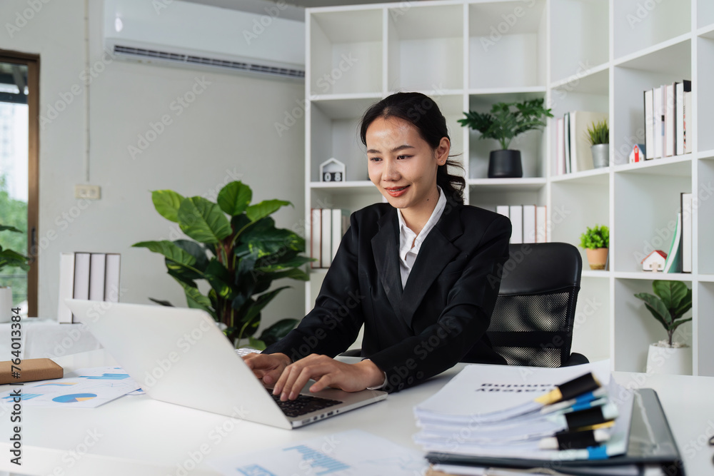 Businesswoman analyzing marketing strategy on laptop, typing work on laptop Businesswoman analyzing marketing strategy on laptop, typing work on laptop